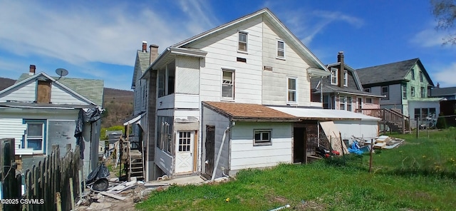 back of house featuring a chimney