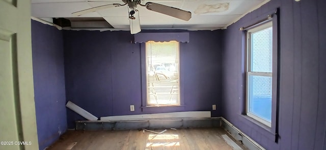 empty room with wood finished floors and a ceiling fan