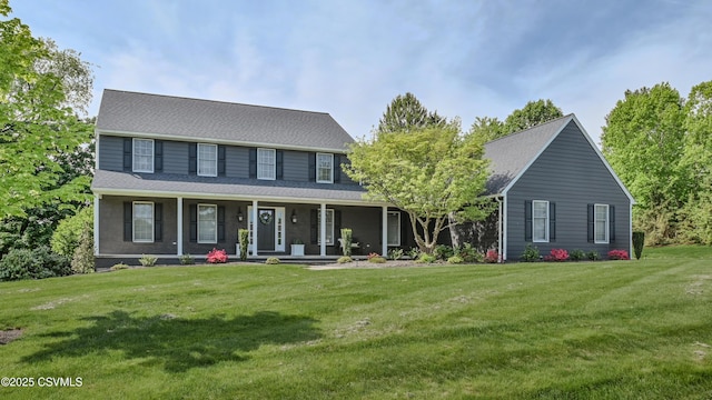 colonial inspired home featuring a front lawn and covered porch