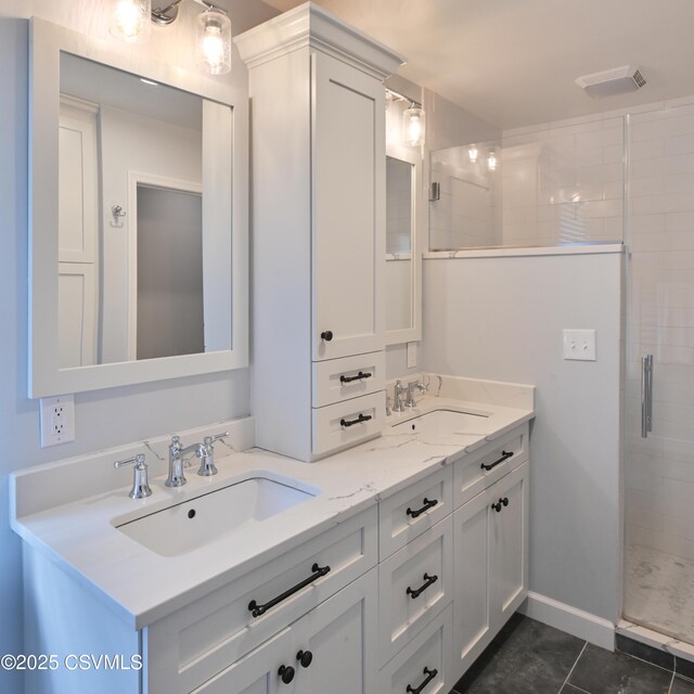 full bath with a tile shower, double vanity, and tile patterned flooring