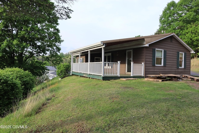 view of front of house with a front yard and a wooden deck