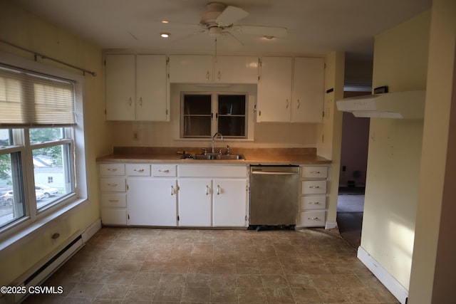 kitchen with stainless steel dishwasher, a sink, a baseboard heating unit, a ceiling fan, and white cabinets