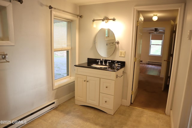 bathroom featuring a baseboard radiator, vanity, baseboards, and ceiling fan