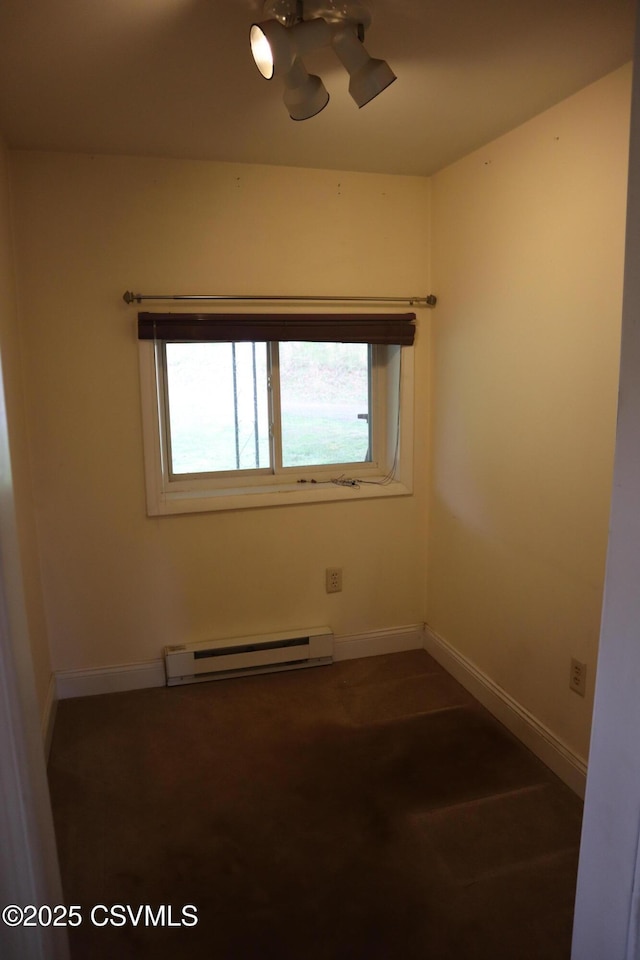 spare room featuring a baseboard radiator and baseboards
