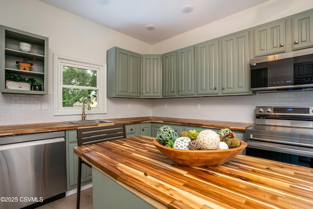501 E 8th St, Berwick, PA 18603 - kitchen featuring butcher block counters, green cabinetry, stainless steel appliances, a sink, and tasteful backsplash