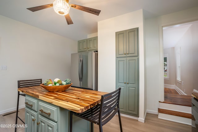 501 E 8th St, Berwick, PA 18603 - dining room with ceiling fan, baseboards, light wood finished floors, and stairway