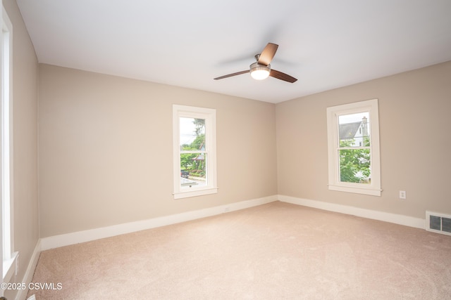 501 E 8th St, Berwick, PA 18603 - empty room featuring light carpet, plenty of natural light, ceiling fan, and baseboards