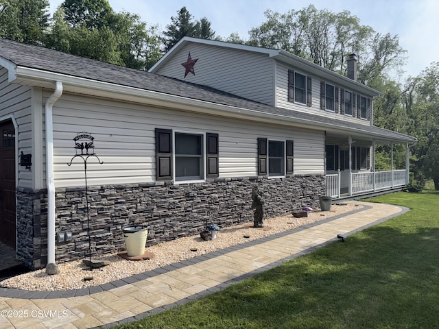 34 Fowlersville Rd, Bloomsburg, PA 17815 - view of side of home featuring covered porch, a lawn, stone siding, a chimney, and roof with shingles