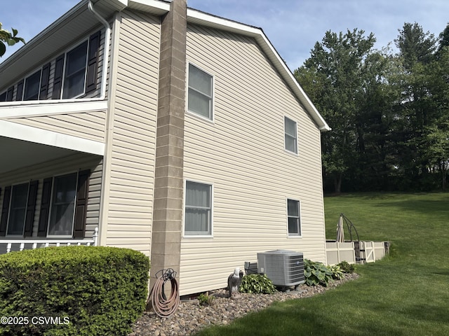 34 Fowlersville Rd, Bloomsburg, PA 17815 - view of property exterior featuring central air condition unit, a lawn, and a chimney