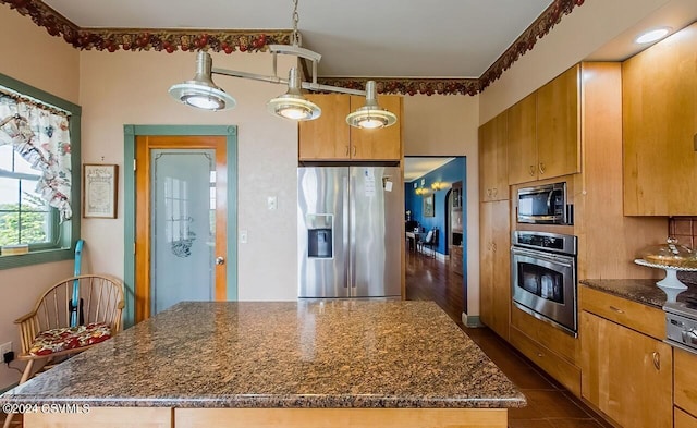 207 Klinger Hill Rd, Benton, PA 17814 - kitchen with stainless steel appliances, a kitchen island, dark stone counters, and dark tile patterned floors