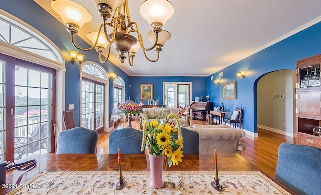 207 Klinger Hill Rd, Benton, PA 17814 - dining room featuring arched walkways, wood finished floors, baseboards, a chandelier, and crown molding