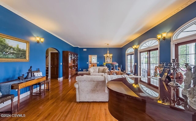 207 Klinger Hill Rd, Benton, PA 17814 - living area featuring arched walkways, wood finished floors, a chandelier, crown molding, and baseboards