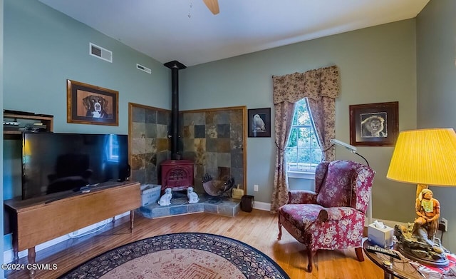 207 Klinger Hill Rd, Benton, PA 17814 - living area featuring a wood stove, wood finished floors, a ceiling fan, and baseboards