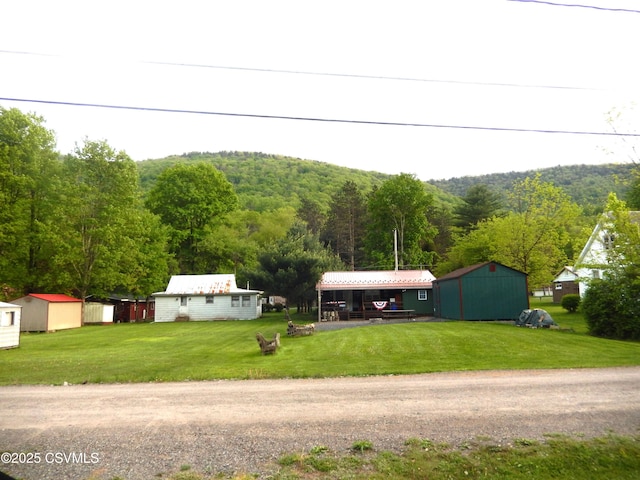 158 Apple Aly, Benton, PA 17814 - view of front of property featuring an outdoor structure, a shed, a forest view, and a front yard