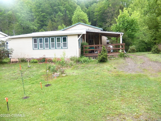 158 Apple Aly, Benton, PA 17814 - view of front of home with a front lawn, a forest view, a deck, and metal roof