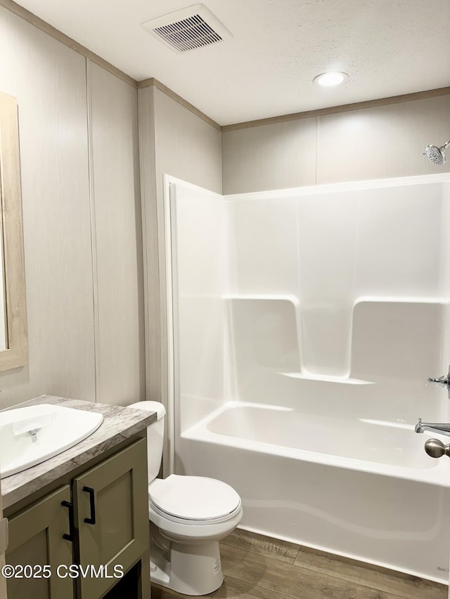 full bath with vanity, toilet, shower / bath combination, and wood finished floors