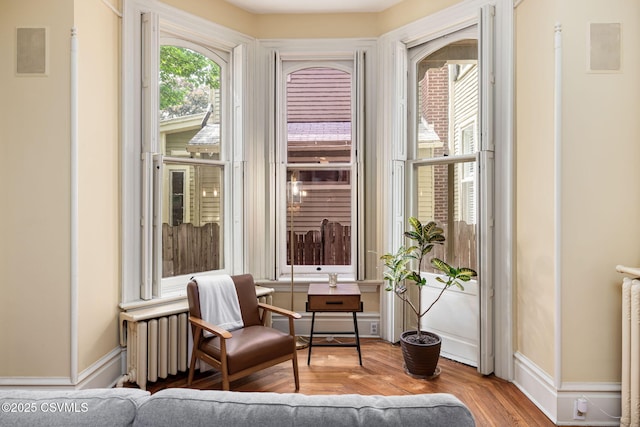 sitting room with wood finished floors and baseboards