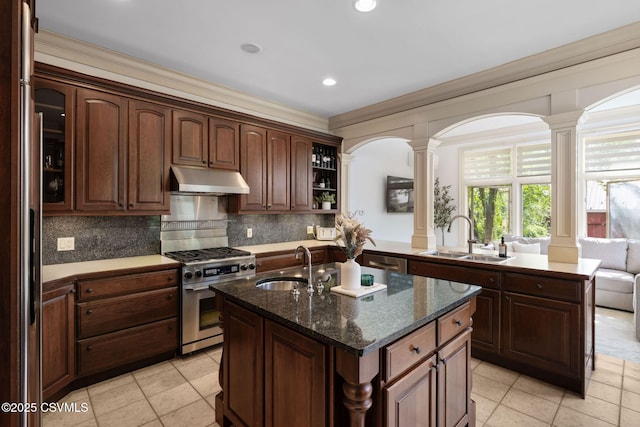 kitchen with stainless steel range with gas cooktop, a sink, ornate columns, ornamental molding, and recessed lighting