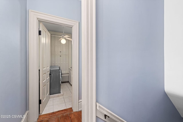 hallway with radiator and wood finished floors