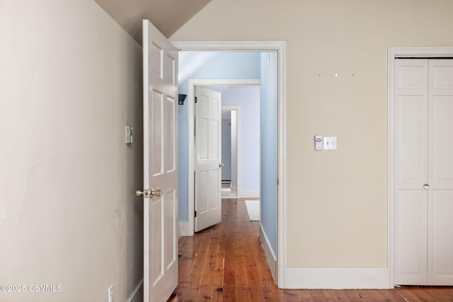 corridor featuring vaulted ceiling and hardwood / wood-style flooring