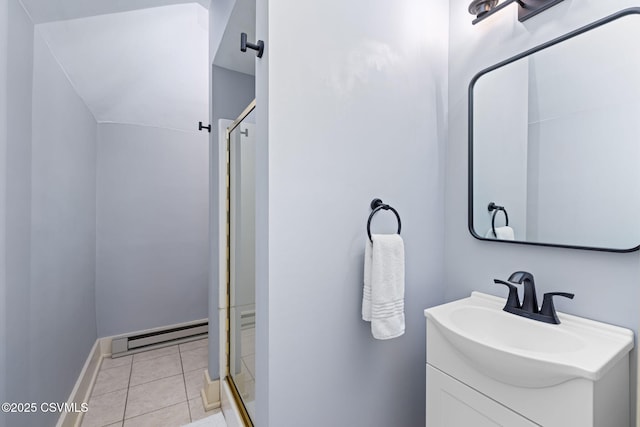 bathroom with a baseboard heating unit, a stall shower, vanity, tile patterned flooring, and baseboards