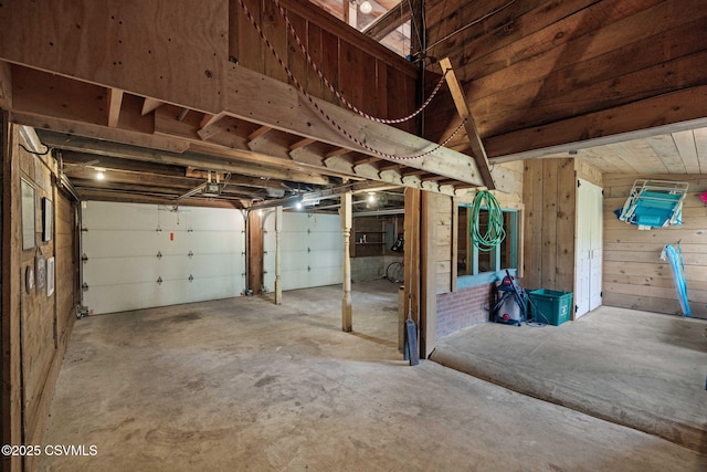 garage featuring wood walls