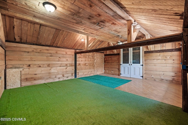 unfurnished room featuring wooden ceiling, lofted ceiling, wood walls, and wood finished floors