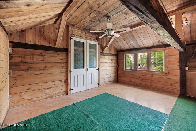 unfurnished room with wooden ceiling, wooden walls, vaulted ceiling, french doors, and ceiling fan