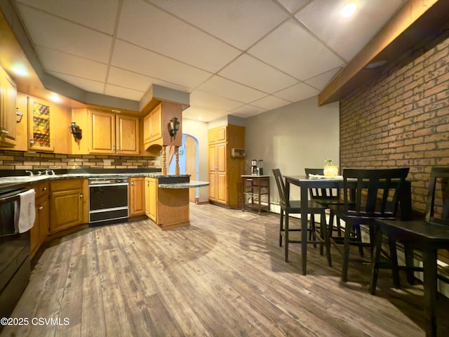 303 Melrose St, Marion Heights, PA 17832 - kitchen featuring black dishwasher, a drop ceiling, wood finished floors, backsplash, and range