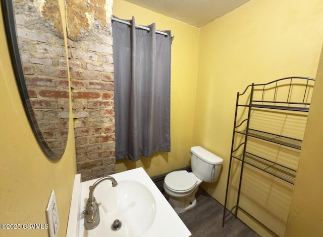 303 Melrose St, Marion Heights, PA 17832 - half bath with a sink, toilet, and wood finished floors