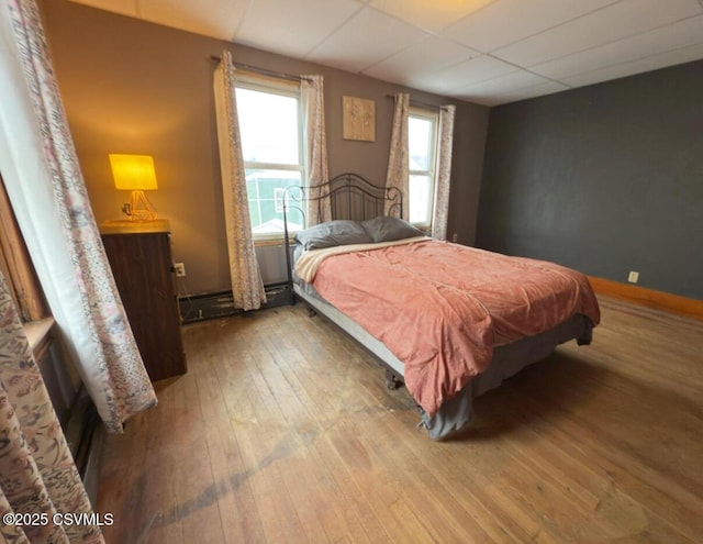 303 Melrose St, Marion Heights, PA 17832 - bedroom with hardwood / wood-style floors, a drop ceiling, and a baseboard heating unit