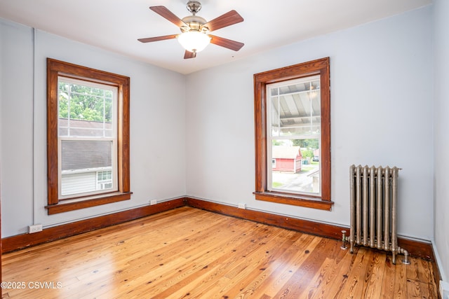 206 Orange St, Selinsgrove, PA 17870 - unfurnished room featuring radiator heating unit, light wood finished floors, baseboards, and a ceiling fan