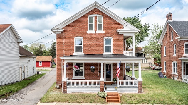 206 Orange St, Selinsgrove, PA 17870 - view of front facade featuring brick siding, a porch, and a front lawn