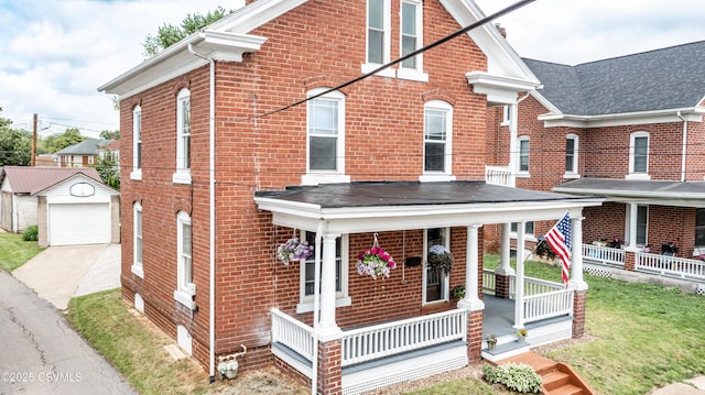 206 Orange St, Selinsgrove, PA 17870 - view of front of house with a porch, an outdoor structure, brick siding, concrete driveway, and a garage