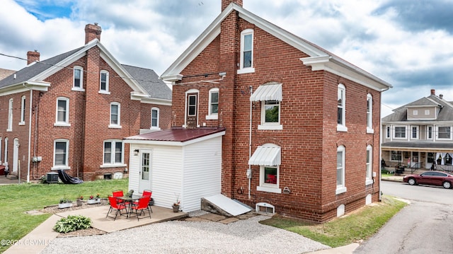 206 Orange St, Selinsgrove, PA 17870 - back of house featuring brick siding, a chimney, and a patio area