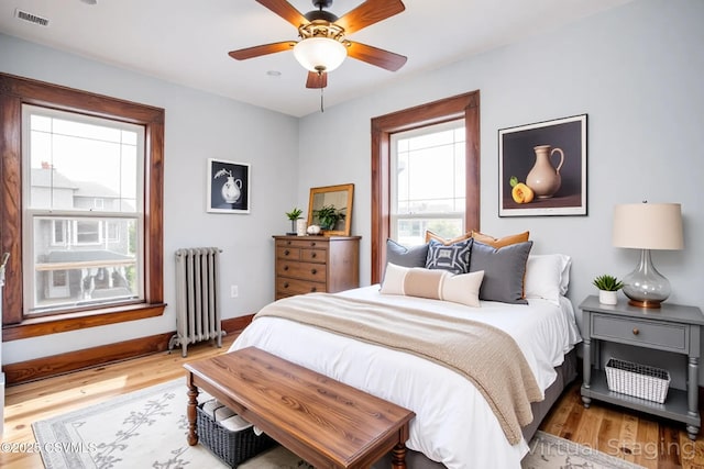 206 Orange St, Selinsgrove, PA 17870 - bedroom with radiator heating unit, light wood-style floors, baseboards, and a ceiling fan