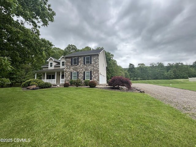 1874 Reading Tpke, Elysburg, PA 17824 - view of front facade featuring a porch, stone siding, a front lawn, and driveway