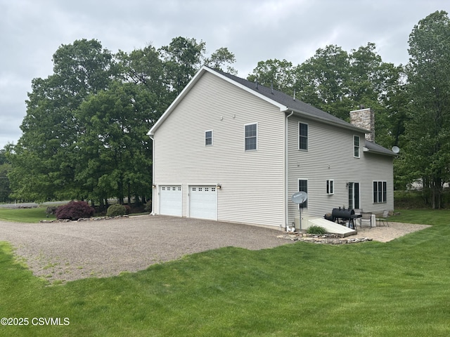 1874 Reading Tpke, Elysburg, PA 17824 - view of home's exterior featuring a chimney, a garage, a yard, and driveway