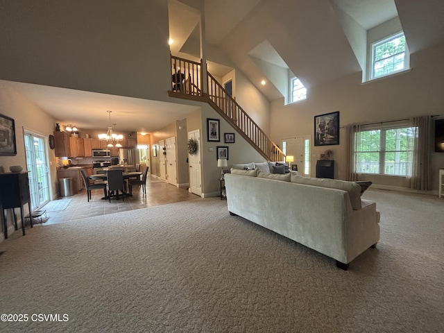 1874 Reading Tpke, Elysburg, PA 17824 - living area featuring a towering ceiling, a chandelier, light colored carpet, stairs, and baseboards