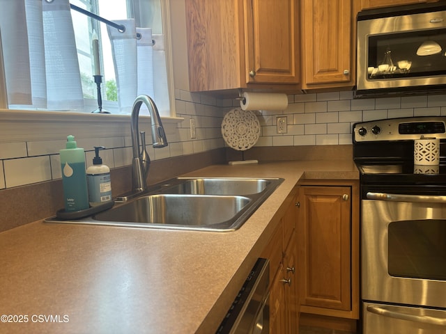 1874 Reading Tpke, Elysburg, PA 17824 - kitchen featuring stainless steel appliances, a sink, backsplash, and brown cabinetry