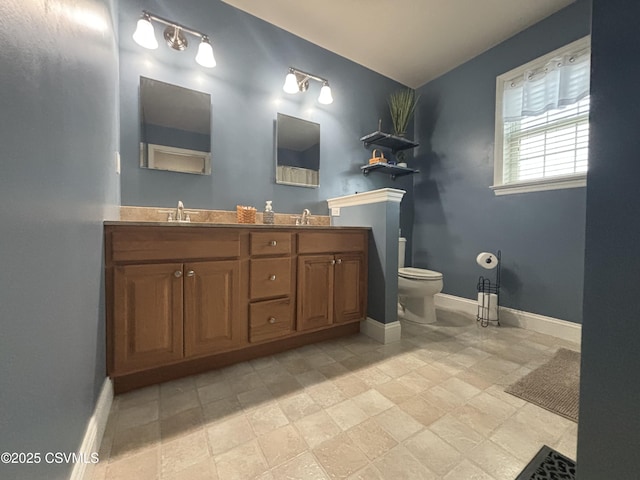 1874 Reading Tpke, Elysburg, PA 17824 - bathroom featuring toilet, baseboards, and double vanity