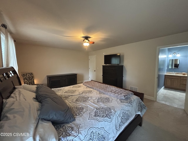 1874 Reading Tpke, Elysburg, PA 17824 - bedroom with light carpet, baseboards, a sink, ensuite bathroom, and a ceiling fan