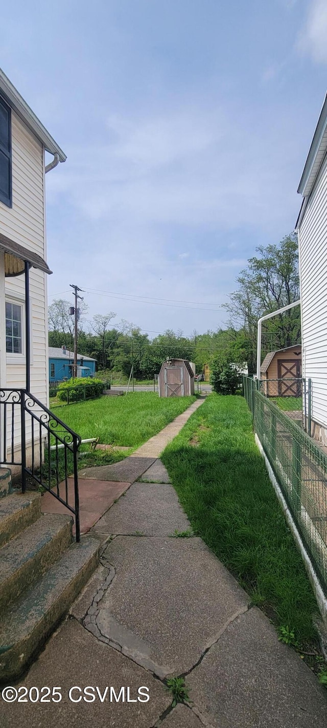 view of yard with a storage shed and an outdoor structure