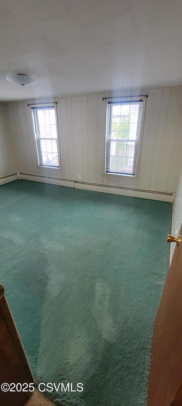 empty room with carpet floors and a decorative wall