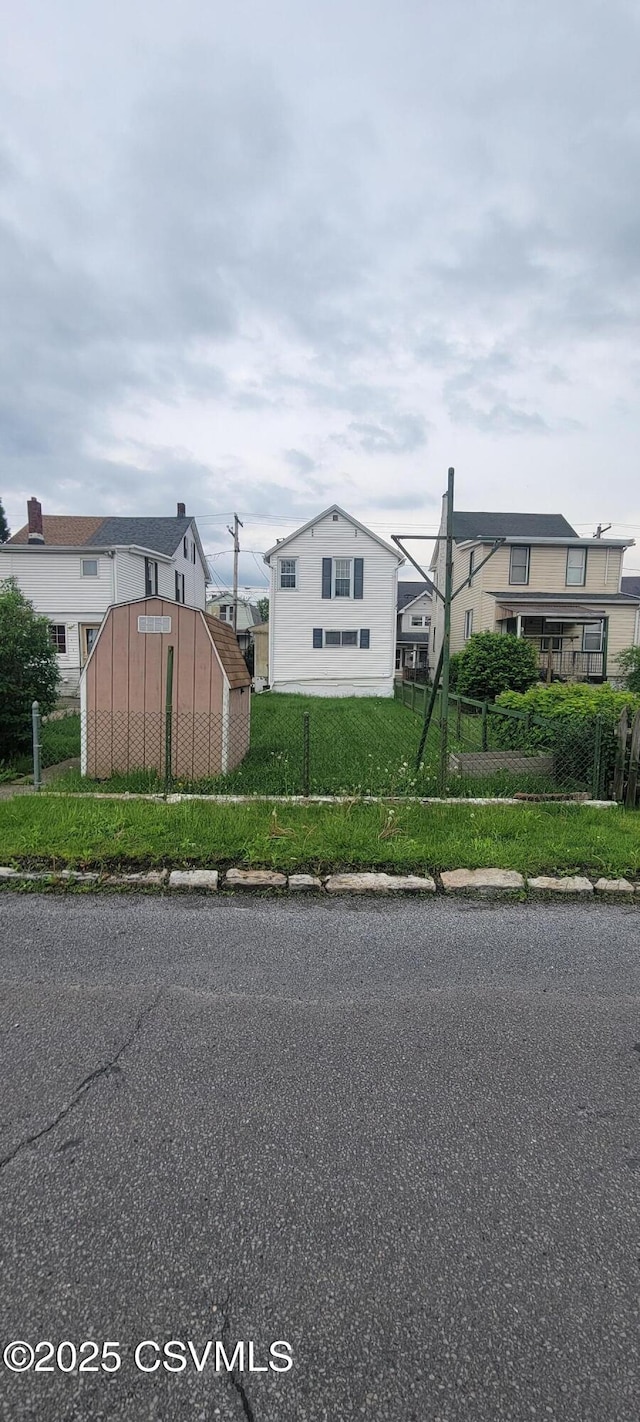 view of asphalt road with curbs and sidewalks