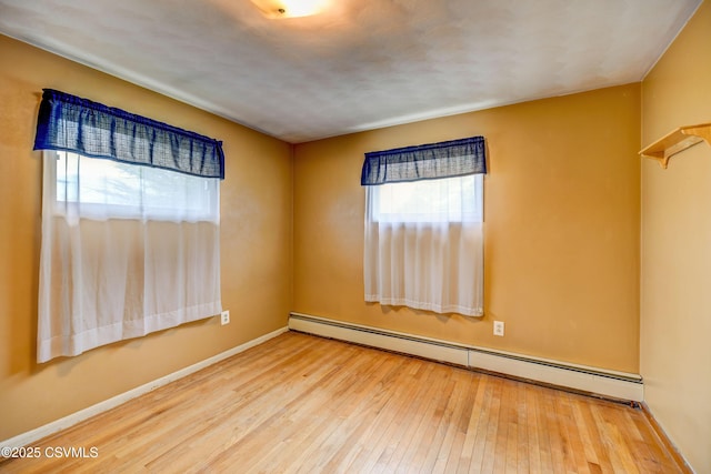 1030 Ruthann Dr, Berwick, PA 18603 - unfurnished room with a baseboard heating unit, hardwood / wood-style floors, and baseboards