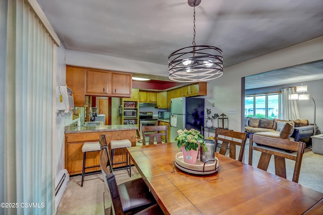 1030 Ruthann Dr, Berwick, PA 18603 - dining space with light carpet, a baseboard radiator, and a chandelier