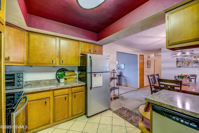1030 Ruthann Dr, Berwick, PA 18603 - kitchen with stainless steel appliances, light countertops, light tile patterned flooring, light colored carpet, and brown cabinetry