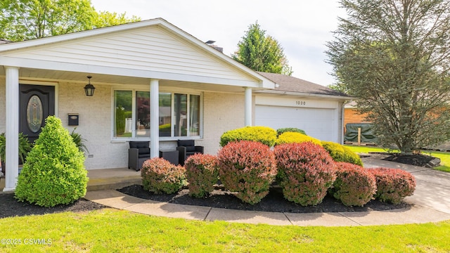1030 Ruthann Dr, Berwick, PA 18603 - view of front facade featuring a porch, a garage, and brick siding