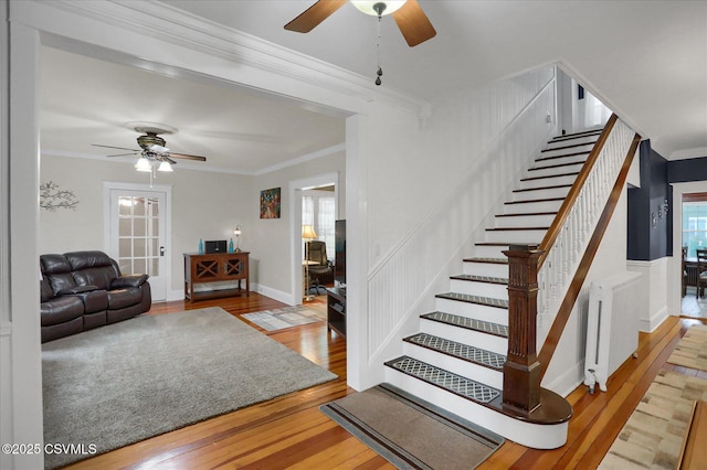 288 Broadway St, Turbotville, PA 17772 - staircase featuring ceiling fan, radiator heating unit, wood-type flooring, and ornamental molding